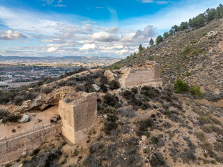 Sticker - Aerial view of medieval Pliego castle partially restored curtain walls, square tower on a hilltop in Southern Spain