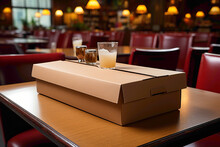 An empty and flattened cardboard takeout box on a table