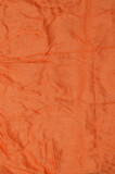 Fototapeta Tulipany - Orange crumpled textile background.