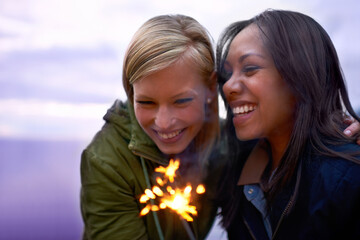 Sticker - Women, friends and happy with sparklers outdoor, celebration and fun with hiking or travel in nature. Friendship, bonding and sparks with horizon, smile for adventure together and evening sky