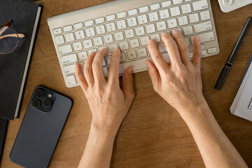 Female hands typing on a computer keyboard