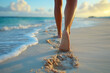 Woman's feet walking on soft white sand in the evening.