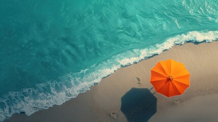 Wall Mural - Orange beach umbrella on sandy coast near sea, top view