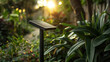 A tiny solar panel integrated seamlessly into a garden lights stem harnessing energy from the sun to power the light.