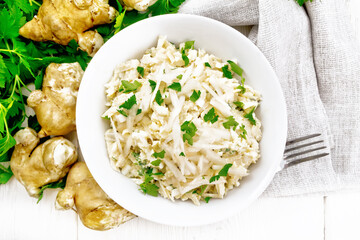 Wall Mural - Salad of Jerusalem artichoke and eggs in plate on board top