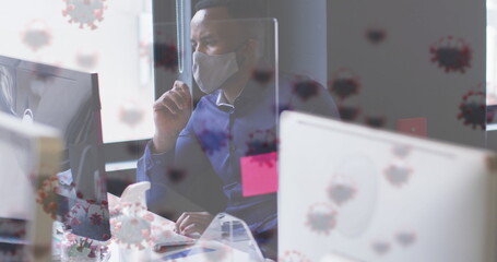 Poster - Image of virus cells over businessman with face mask using computer in office