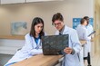 © StockPhotoRepublic - Doctors working together looking at a x-ray scan discussing solution and idea for a medical case in a hospital