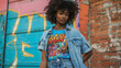 A bold and colorful graphic tshirt tucked into highwaisted mom jeans layered with a vintage denim jacket and chunky ankle boots for a grungeinspired 90s meets 70s look.