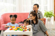 © Art_Photo - Portrait of enjoy happy love asian family father and mother with little asian girl smiling activity learn and skill brain training play with toy build wooden blocks board education game at home