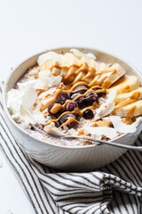 Wall Mural - Overnight oatmeal with banana, berries, coconut chips and peanut butter.