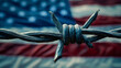 Close-up of barbed wire with blurred American flag in the background, symbolizing restricted freedom or illegal border crossing into the United States