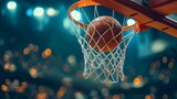 Fototapeta Sport - Closeup of an orange basketball ball passing through a rim or ring with a net, basketball indoors arena with a hoop and the backboard. Sphere or circle, round object for shooting and scoring in a gym