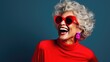 © ZEKINDIGITAL - Senior Woman in Colorful Attire Laughing