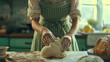 © Caelestiss - Woman in gingham apron is kneading dough. Cottagecore rustic kitchen. Homemade cooking. Artisan bread.