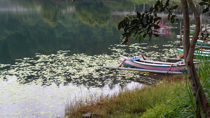 Wall Mural - Beautiful lake view with wooden fishing boats, bridge and the water reflections. Part of The Baratan Lake, Bedugul, Bali - Indonesia