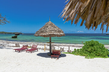 Canvas Print - Chair and green trees on a white sand beach. Watamu, Kenya - Africa.