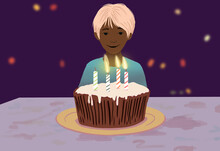 Smiling Child With Birthday Cake And Lit Candles