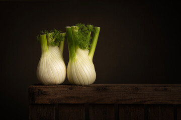 Wall Mural - Two fennel bulb on a wooden crate in a still life setting