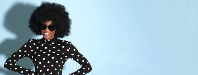 Wall Mural - Happy black woman in a polka-dot blouse.