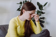 © Yura Yarema - Close up portrait of upset sad young woman has dizziness and motion blurry sitting alone on sofa in living room at home. Brain stroke or low blood pressure symptom on people medical concept