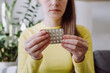 © Yura Yarema - Selective focus of young girl hands holding hormonal oral contraceptive medicine, take pharmaceutical to prevention, safe virus sex disease, contraception, menstruation concept, birth control pills