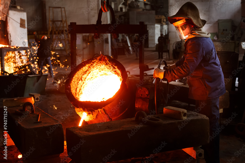 Foundry Working Industrial worker pours molten metal at foundry. Steel production in ...