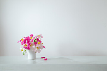 Wall Mural - white and pink  tulips in white vase on background wall