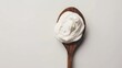 © buraratn - Sour cream in spoon on white background