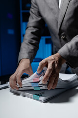 Wall Mural - An employee held a large pile of documents in his hand, Large piles of work documents on desks are being sorted by employees, Important documents are stacked.