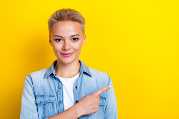 Wall Mural - Photo portrait of lovely young lady point empty space promo mockup dressed stylish denim garment isolated on yellow color background