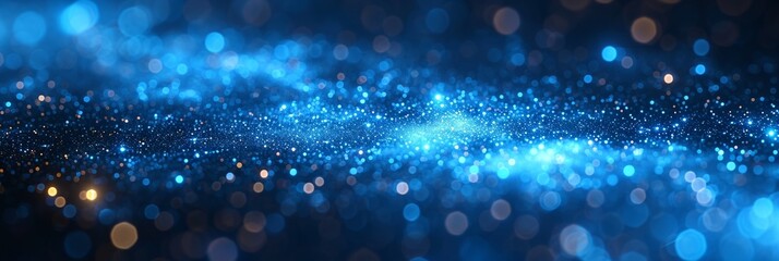 A glittering and shimmering abstract background with blue bokeh lights resembling sparkling sand.