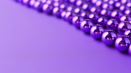 Beads on a purple background, suitable for design with copy space, Mardi Gras celebration.
