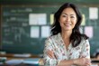 © Danko - a photo portrait of a beautiful adult asian school teacher standing in the classroom