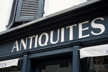Closeup Of Antiques Signage On Store Front In The Street, Traduction In English Of Antiquités In French
