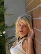 Outdoor Portrait Young Blond Caucasian Woman On Brick Wall