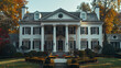 A suburban colonial-style home with symmetrical features, camera emphasizing the classic architecture and the crispness of the white columns against a clear day.