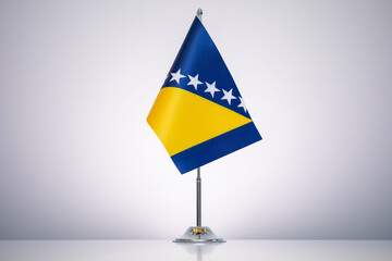 Wall Mural - Bosnia and Herzegovina flag with a gray and clean background.