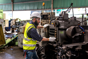 Wall Mural - Industrial engineer man working with heavy machinery in manufacturing industry