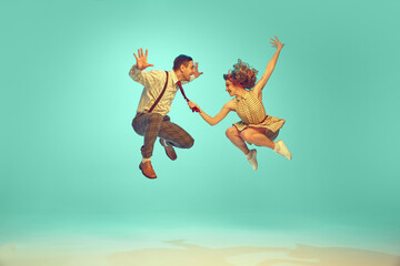 portrait of modern jazz-dancers in mid-air against gradient mint background. joyful dance partners p