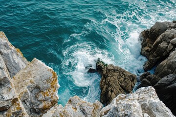 Poster - This photo captures a birds-eye view of the vast ocean as seen from the top of a towering cliff, Elevated capture of the seaâ€™s restive dance around the edgy rocks, AI Generated