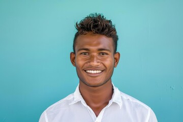 Wall Mural - Man smiling in a white shirt Portrait against a blue background Embodying confidence and simplicity