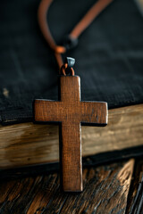 Wall Mural - Closeup of wooden Christian cross necklace next to holy Bible
