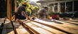 Builders focused on constructing a wooden deck for a residential property