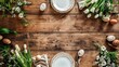 Easter table setting, easter eggs and flowers decoration on wooden background, top view