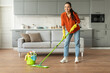 © Prostock-studio - Woman mopping floor with bright smile and bucket