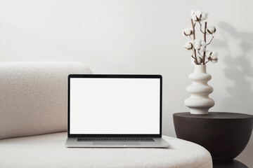 laptop computer with empty blank mockup screen over white modern living room design. advertisement, 