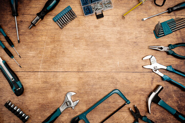 Wall Mural - Assorted Hand Tools Laid Out on wooden background, top view with space for text