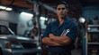 © Studio Nova - confident male mechanic in a workshop, wearing a dark blue uniform and a baseball cap, with a wrench in hand, standing in front of a car and mechanical equipment