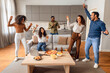 © Prostock-studio - Cheerful diverse group students dancing and singing in living room