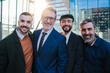 © Jose Calsina - Portrait of a group of business men looking at camera with smiley expression. Male coworkers staring front. Masculine professional guys smiling. Meeting of real corporate businesspeople. Job teamwork